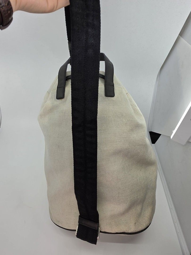 Prada Canapa Knapsack (Category: Luxury Bags & Wallets) located in Quezon City. Submitted by nadine_miel (Listing ID 1453031318, Image 2). Description: Project bag⚠️ Prada Canapa Knapsack body bag have visible discoloration on the canvas leather trimming sa drawstring mejo buka na but still perfect pa naman conditiob perfect pa to pang harabas or png pickle ball ksi madmi malalagay.