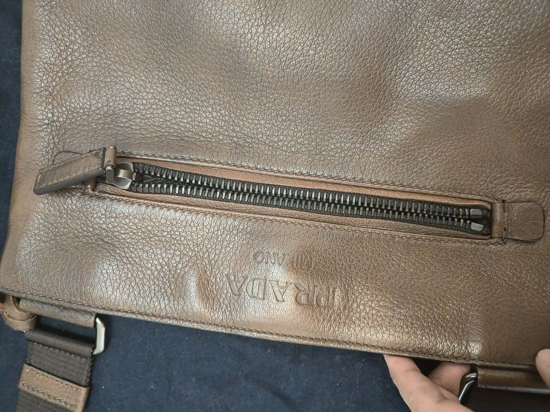 Prada Milano Brown Leather Crossbody Bag (Category: Luxury Bags & Wallets) located in Makati City. Submitted by iamemztot_1992 (Listing ID 1452931389, Image 2). Description: - Authentic Prada crossbody bag - Textured brown leather - Front zip pocket - Adjustable strap - Interior zip pocket - Comes with Prada dust bag - Ideal for everyday use.