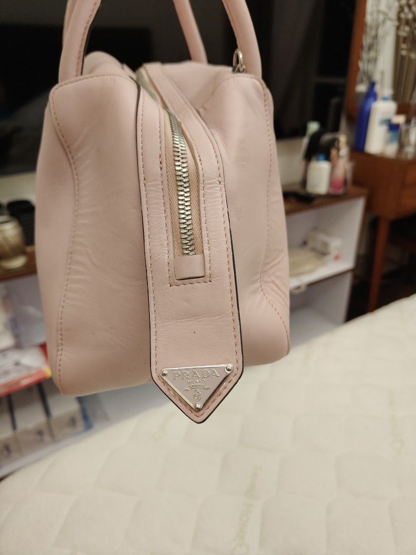Prada Milano Pink Leather Top Handle Bag (Category: Luxury Bags & Wallets) located in Pasay City. Submitted by janiell (Listing ID 1452991179, Image 3). Description: - Authentic Prada bag - Lovely pastel pink color - Made from genuine leather - Features top handles - Includes a detachable shoulder strap - Smooth zip closure - Comes with a Prada triangle logo charm - Versatile for daily use or special occasions.