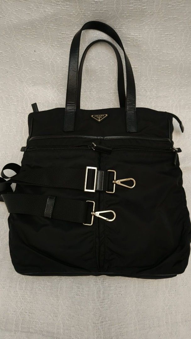 Prada Nylon Tote Bag with Shoulder Strap (Category: Luxury Bags & Wallets) located in Makati City. Submitted by iamemztot_1992 (Listing ID 1452927674, Image 3). Description: - Authentic Prada nylon tote bag - Features leather handles and trim - Includes a detachable shoulder strap - Multiple zippered compartments for organization - Prada logo hardware - Ideal for everyday use.