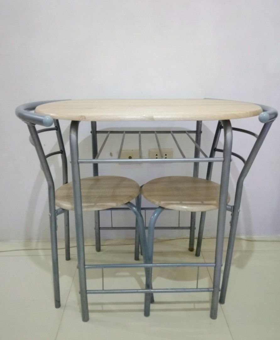 Space-Saving 2-Seater Dining Set (Category: Tables & Sets) located in Makati City. Submitted by foryoufindsph (Listing ID 1452889479, Image 2). Description: ​🪑 Space-Saving 2-Seater Dining Set 💸 Price: ₱2,899 ​Clean, minimal, and ultra-functional! Perfect for condo living, small apartments, or cozy kitchen nooks. ☕✨ ​📌 Highlights: ​Includes: 1 table + 2 Tuck-In chairs ​Frame: Sturdy Powder-Coated Metal ​Top/Seats: Wood-Laminate Finish ​Conditi