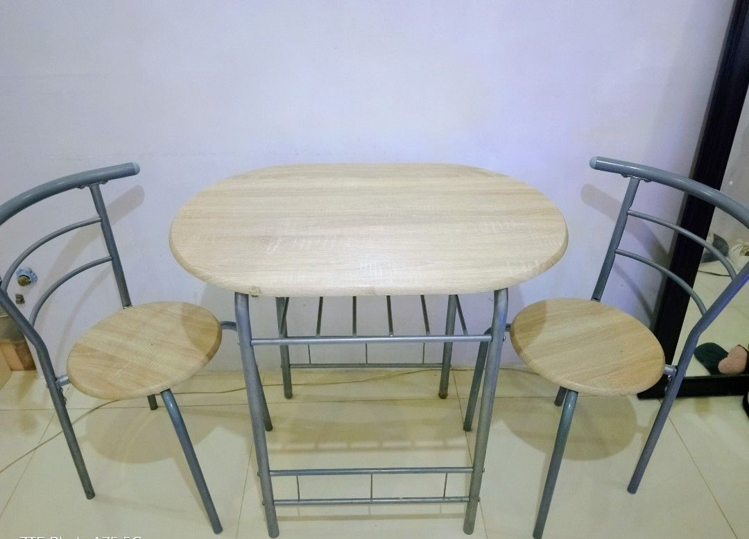 Space-Saving 2-Seater Dining Set (Category: Tables & Sets) located in Makati City. Submitted by foryoufindsph (Listing ID 1452889479, Image 1). Description: ​🪑 Space-Saving 2-Seater Dining Set 💸 Price: ₱2,899 ​Clean, minimal, and ultra-functional! Perfect for condo living, small apartments, or cozy kitchen nooks. ☕✨ ​📌 Highlights: ​Includes: 1 table + 2 Tuck-In chairs ​Frame: Sturdy Powder-Coated Metal ​Top/Seats: Wood-Laminate Finish ​Conditi