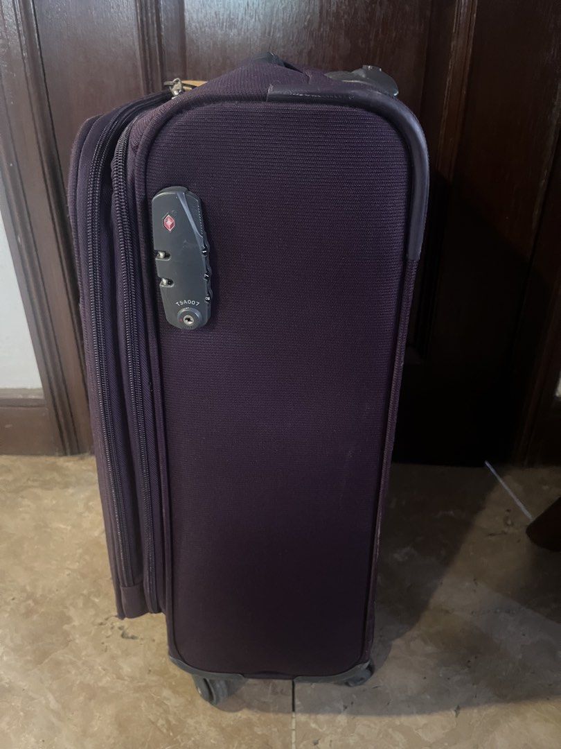Samsonite Purple Softside Spinner Luggage (Category: Luggage) located in Caloocan City. Submitted by issastore (Listing ID 1452914145, Image 2). Description: - Purple Samsonite spinner luggage - Features a TSA lock for security - Wheels are intact and functional - Secure zipper closure - Minor scuffs on the handle area - Perfect for your next trip!.
