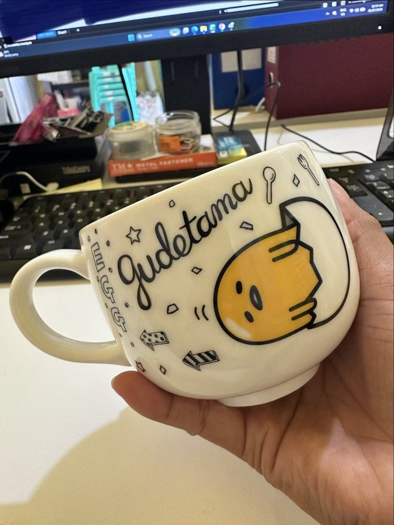 Sanrio Gudetama Mug and Spoon Set '22 (Category: Dinnerware & Cutlery) located in Baguio. Submitted by gayecee (Listing ID 1452907890, Image 2). Description: - Adorable Gudetama mug with all-over designs. - Includes a matching spoon with Gudetama's face on the handle. - Ideal for coffee, tea, or as a gift for Gudetama fans. - Authentic Sanrio product from 2022..