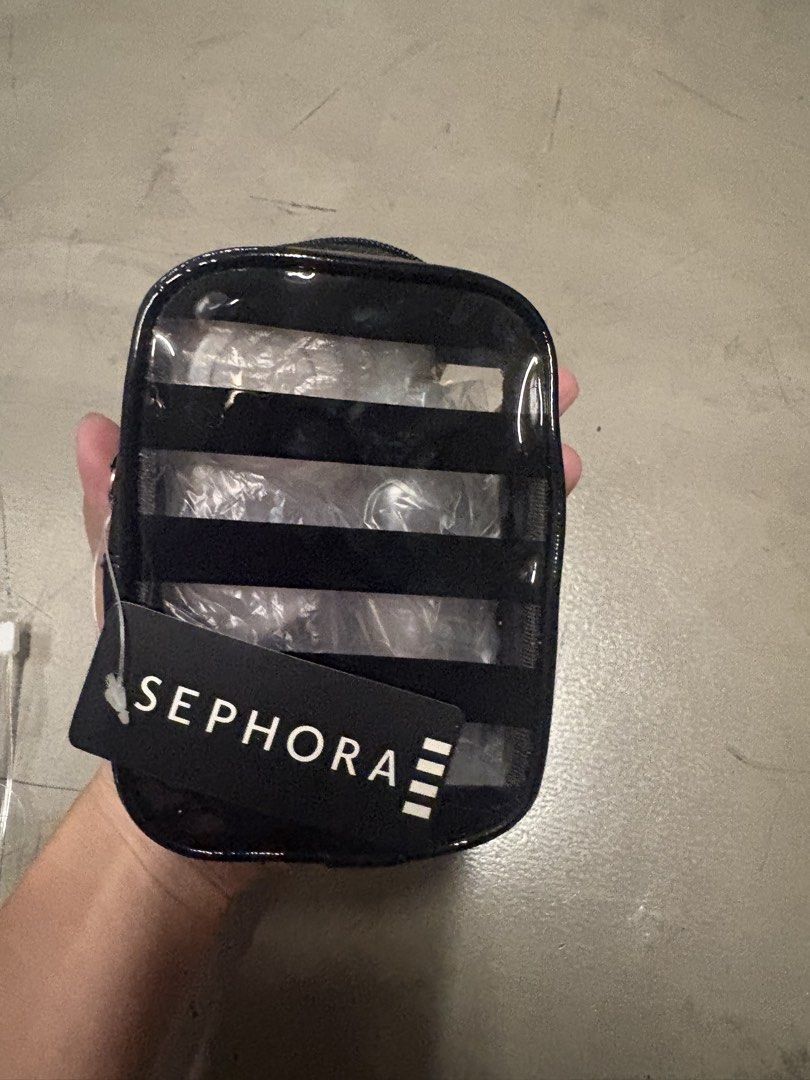 Sephora Clear Cosmetic Bag with Black Trim (Category: Makeup) located in Quezon City. Submitted by clarisse_onlineshop (Listing ID 1453045477, Image 1). Description: - Authentic Sephora clear cosmetic bag - Stylish black trim and zipper - Multiple horizontal clear compartments inside for easy organization - Comes with original Sephora tag - Ideal for storing makeup, toiletries, or travel essentials - Compact and travel-friendly size - Easy to wip