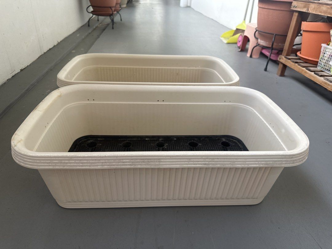 Set of 2 White Rectangular Planter Boxes with Inserts (Category: Pots & Planters) located in Singapore. Submitted by pg-21 (Listing ID 1452975813, Image 1). Description: - Set of 2 white rectangular planter boxes - Includes black inner pots with drainage holes .