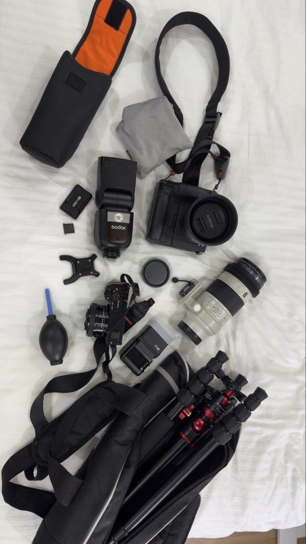 Sony Camera Bundle with Lenses, Flash, Tripod, and Bag (Category: Cameras) located in Agdangan. Submitted by oqihm (Listing ID 1452911954, Image 3). Description: - 2 Sony Camera Body - 2 Sony Lenses - Godox Flash - Tripod - Carrying Bag - Ideal for photography enthusiasts - All items pictured - Message for questions Sony A7III with grip and 2 cards(64gb Sony) Complete with box Price: 60k (negotiable) Sony ZV E10 mark i with kits lens Complete wit