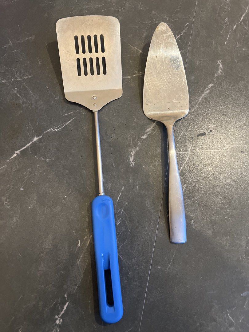 Spatula and Cake Server Set (Category: Dinnerware & Cutlery) located in Cebu City. Submitted by zershrovv (Listing ID 1452968002, Image 1). Description: - Set includes a metal slotted spatula and a metal cake server. - Spatula features a comfortable blue handle for easy grip. - Ideal for flipping food while cooking or serving cakes and desserts. - Durable metal construction for long-lasting use..