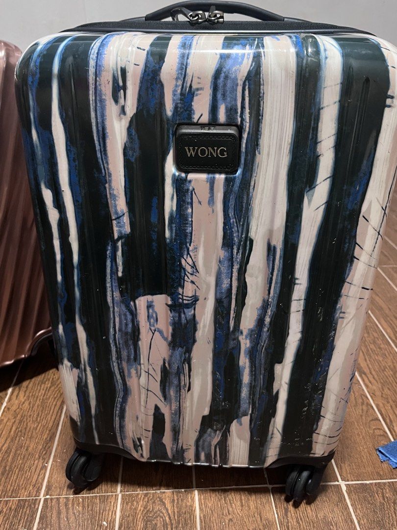 TUMI Luggage Suitcase - Unique Abstract Print (Category: Luggage) located in Victorias. Submitted by lan1877 (Listing ID 1452880694, Image 1). Description: - Stylish TUMI suitcase with a unique abstract print. - Equipped with a TSA-approved lock for security. - Effortless maneuverability with four smooth-gliding spinner wheels. - Interior lined with signature TUMI branding. - Zippers are fully functional and glide smoothly. - Ideal travel compani