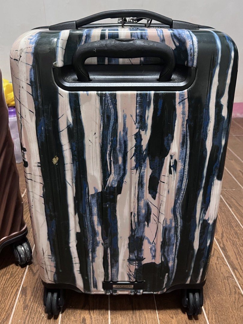 TUMI Luggage Suitcase - Unique Abstract Print (Category: Luggage) located in Victorias. Submitted by lan1877 (Listing ID 1452880694, Image 2). Description: - Stylish TUMI suitcase with a unique abstract print. - Equipped with a TSA-approved lock for security. - Effortless maneuverability with four smooth-gliding spinner wheels. - Interior lined with signature TUMI branding. - Zippers are fully functional and glide smoothly. - Ideal travel compani