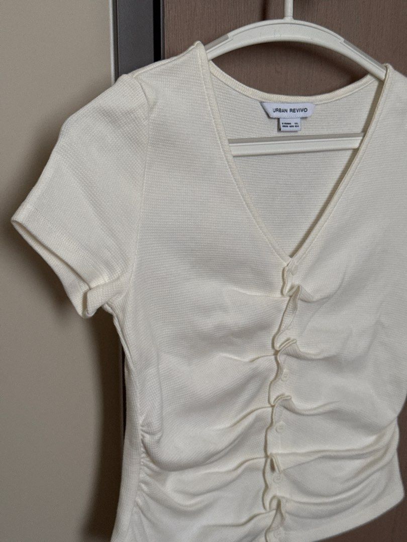 Urban Revivo White Ruched Top (Category: Blouses) located in Manila. Submitted by je2ny (Listing ID 1431942582, Image 2). Description: RFS: Decluttering Bust: 38cm Top Length: 46cm Arm Hole: 13cm - Urban Revivo white top - V-neck design - Short sleeves - Ruched front with button details.