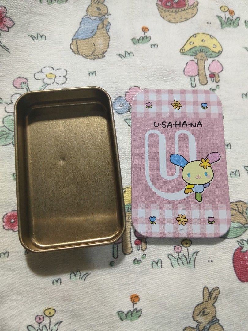 Usahana Tin Boxes (Category: Storage Boxes & Baskets) located in Pagsanjan. Submitted by calmcloud-17d6 (Listing ID 1453022175, Image 2). Description: - Adorable tin boxes featuring Sanrio characters and Usahana. - Ideal for storing stationery, accessories, or trinkets. - Sanrio tin: White with pastel hearts & stars. - Usahana tin: Pink checkered pattern with Usahana graphic. - Rectangular shape with rounded corners. - Great for Sanrio fans and c