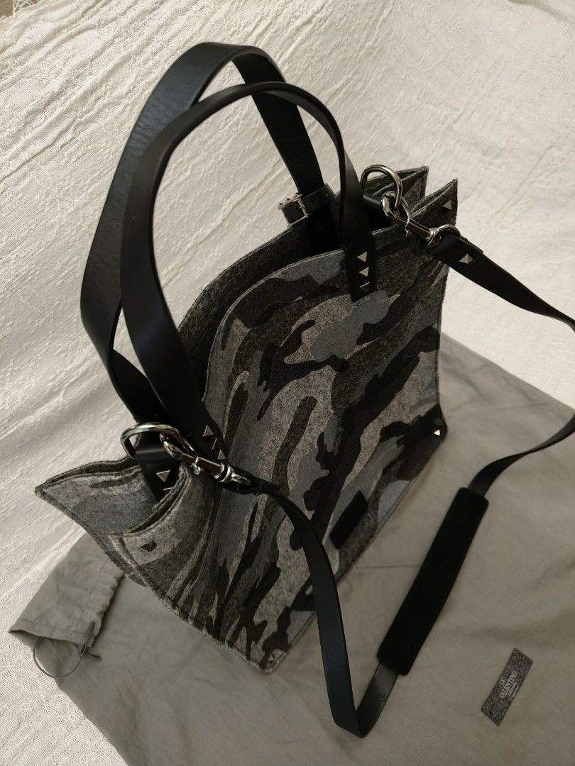 Valentino Camouflage Felt Tote Bag with Studs (Category: Luxury Bags & Wallets) located in Makati City. Submitted by iamemztot_1992 (Listing ID 1452931640, Image 1). Description: - Valentino tote bag - Grey camouflage pattern - Felt material with leather handles and trim - Signature Valentino pyramid studs - Detachable shoulder strap included - Comes with dust bag - Ideal for everyday use.