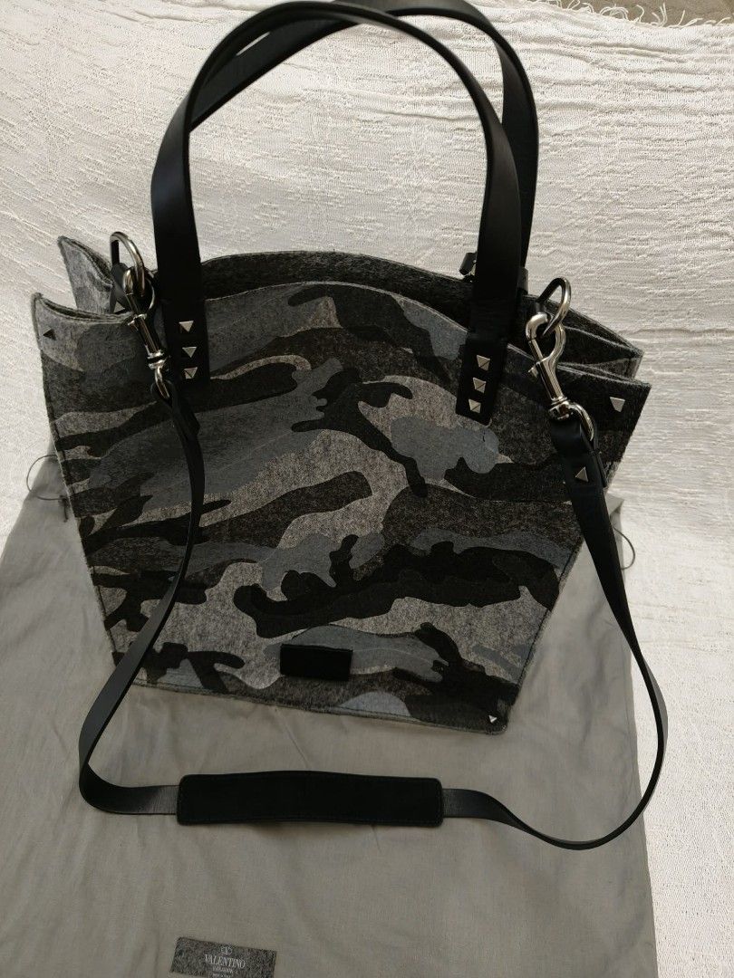 Valentino Camouflage Felt Tote Bag with Studs (Category: Luxury Bags & Wallets) located in Makati City. Submitted by iamemztot_1992 (Listing ID 1452931640, Image 2). Description: - Valentino tote bag - Grey camouflage pattern - Felt material with leather handles and trim - Signature Valentino pyramid studs - Detachable shoulder strap included - Comes with dust bag - Ideal for everyday use.