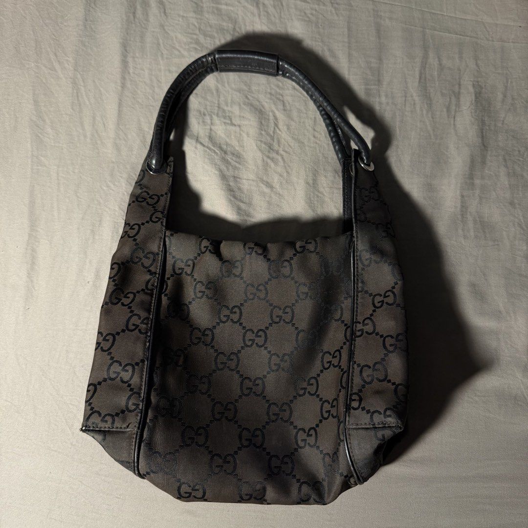 VINTAGE GUCCI MONOGRAM NYLON SHOULDER BAG (Category: Luxury Bags & Wallets) located in Lubao. Submitted by the_elusive_shop (Listing ID 1453020054, Image 2). Description: 100% AUTHENTIC VINTAGE GUCCI DARK BROWN GG MONOGRAM BAG Condition: Good vintage condition with normal signs of wear for its age. The leather zipper pull/strap is no longer attached but the zipper itself still works fine. Please check all photos for the overall condition. NOTE: N