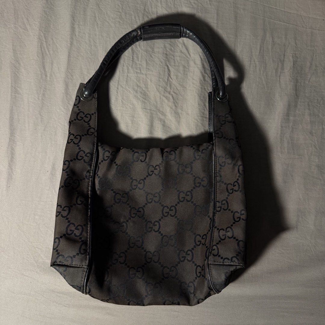 VINTAGE GUCCI MONOGRAM NYLON SHOULDER BAG (Category: Luxury Bags & Wallets) located in Lubao. Submitted by the_elusive_shop (Listing ID 1453020054, Image 1). Description: 100% AUTHENTIC VINTAGE GUCCI DARK BROWN GG MONOGRAM BAG Condition: Good vintage condition with normal signs of wear for its age. The leather zipper pull/strap is no longer attached but the zipper itself still works fine. Please check all photos for the overall condition. NOTE: N