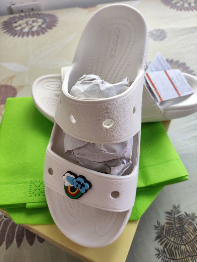 White Crocs Slides with Rainbow Charm (Category: Slippers and slides) located in Manila. Submitted by liveflower.5e2897 (Listing ID 1452998546, Image 1). Description: - White Crocs slides - Comes with a cute rainbow charm - Size M7/W9 - Ideal for casual wear, beach trips, or lounging - Easy slip-on and off design .
