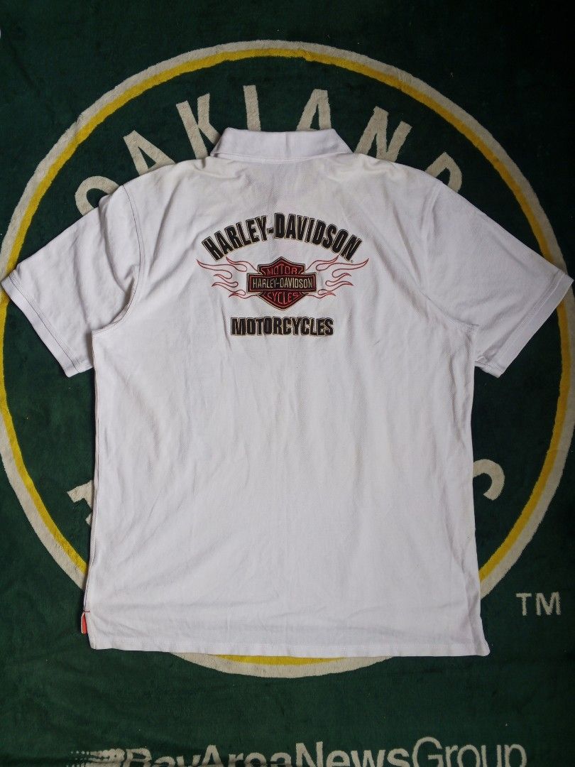 White Harley-Davidson Polo Shirt with Flame Graphics (Category: Tshirts & Polo Shirts ) located in Las Pinas. Submitted by allhandpick (Listing ID 1453019909, Image 3). Description: - White Harley-Davidson polo shirt - Features flame graphics on front and back - Classic collar with button closure - Comfortable cotton blend fabric - Ideal for any Harley-Davidson enthusiast.
