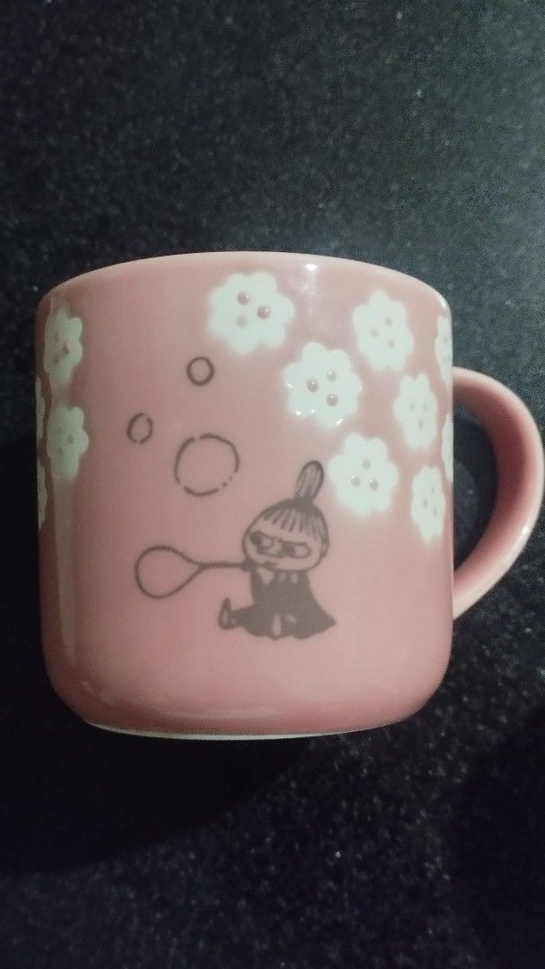 Yamaka Shoten Moomin Mug (Category: Coffee & Tea Tableware) located in Bacoor. Submitted by gonzagaobet (Listing ID 1452938601, Image 1). Description: Yamaka Shoten Moomin "Florit" porcelain mug featuring Little My blowing bubbles. - Adorable pink Moomin mug, imported from Japan. - Features a charming Moomin character blowing bubbles amidst scattered flowers. - Interior of the mug is also a lovely shade of pink. - Ideal for enjoying your morning 