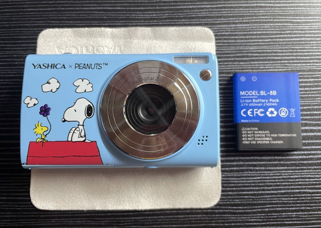 Yashica x Peanuts Snoopy Digital Camera / Digicam (Blue Sky) (Category: Cameras) located in Quezon City. Submitted by erinp123 (Listing ID 1453016462, Image 2). Description: - Only used once for testing - With original box - All inclusions complete: Charger cord, Battery, Pouch case, Microfiber cloth, Lanyard, Stickers, Keychain (top part broken) - Sample photos included above - Fixed price, non-negotiable (original price was around ₱6500+) .