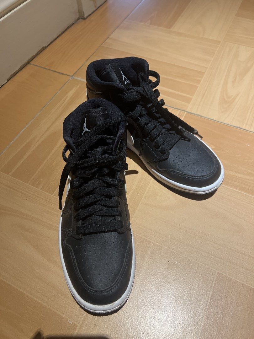 Authentic Air Jordan 1 Mid Black White Sneakers (Category: Sneakers) located in Bulacan. Submitted by fallongallon (Listing ID 1447540334, Image 2). Description: - Classic black and white colorway - Mid-top silhouette - Lace-up closure - Iconic Jumpman logo on tongue - Air Jordan Wings logo on ankle collar - White midsole with black outsole - Ideal for everyday wear 24cm.