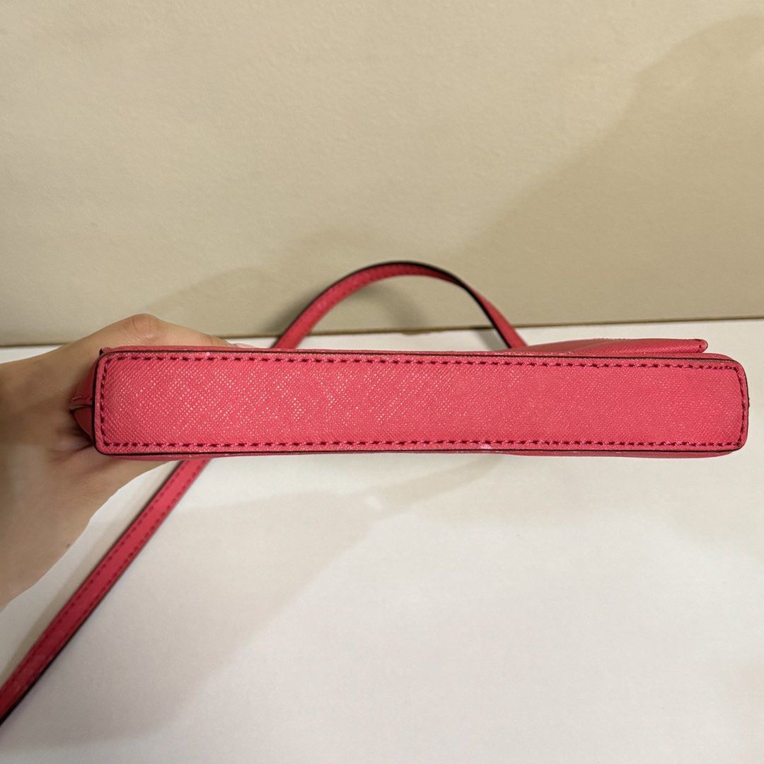 Authentic Kate Spade Pink Crossbody Bag with Silver Turnlock (Category: Cross-body Bags) located in Pasig City. Submitted by _sfoo (Listing ID 1447630721, Image 3). Description: - Authentic - Condition: 7/10 (no issues on the inside, just a few stains. exterior has leather cracks and hardware scratches) - Signature silver turnlock closure - Fits iPhone Pro Max and passport - Comes with tag and care card No returns/refund after payment.