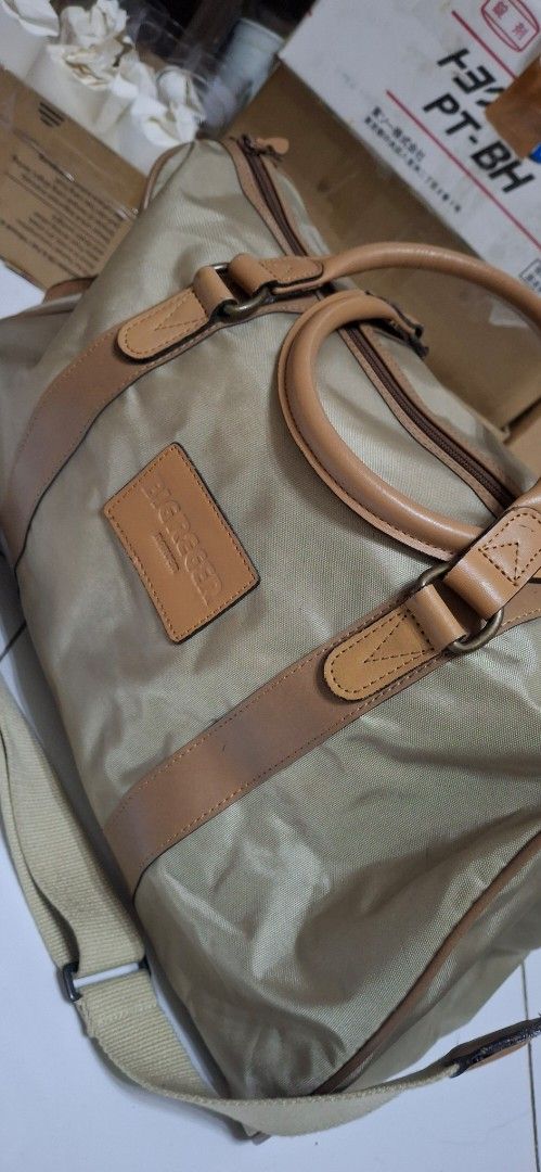 BIG REGER Canvas Leather Trim Duffel Bag (Category: Sling Bags) located in Manila. Submitted by youngcloud_b1fffa (Listing ID 1447667644, Image 2). Description: - Classic beige canvas duffel bag - Tan leather trim and handles - Detachable shoulder strap included - Zippers are in good working condition - Perfect size for weekend getaways or gym sessions - Shows minor marks on canvas, but overall in good shape - Ready for your next adventure! "R&B 