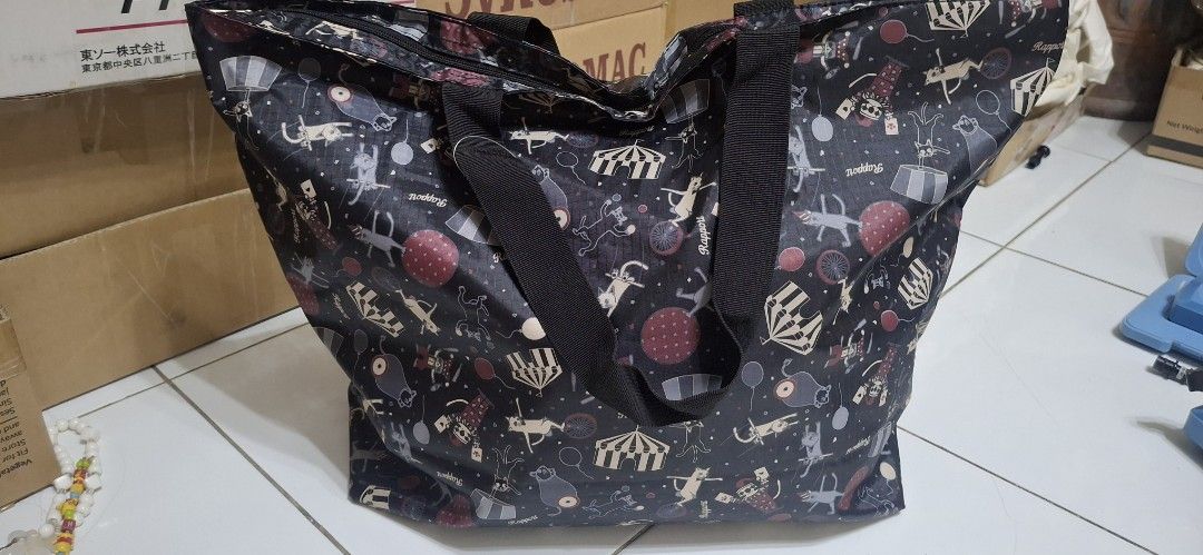Black Circus Cat Print Tote Bag (Category: Tote Bags) located in Manila. Submitted by youngcloud_b1fffa (Listing ID 1447658063, Image 1). Description: - Adorable black tote bag featuring a playful circus cat print. - Secure zippered closure to keep your belongings safe. - Two sturdy handles for comfortable carrying. - Interior lined with a cheerful light blue fabric. - Includes an internal zippered pocket for extra organization. - Ideal for shopp