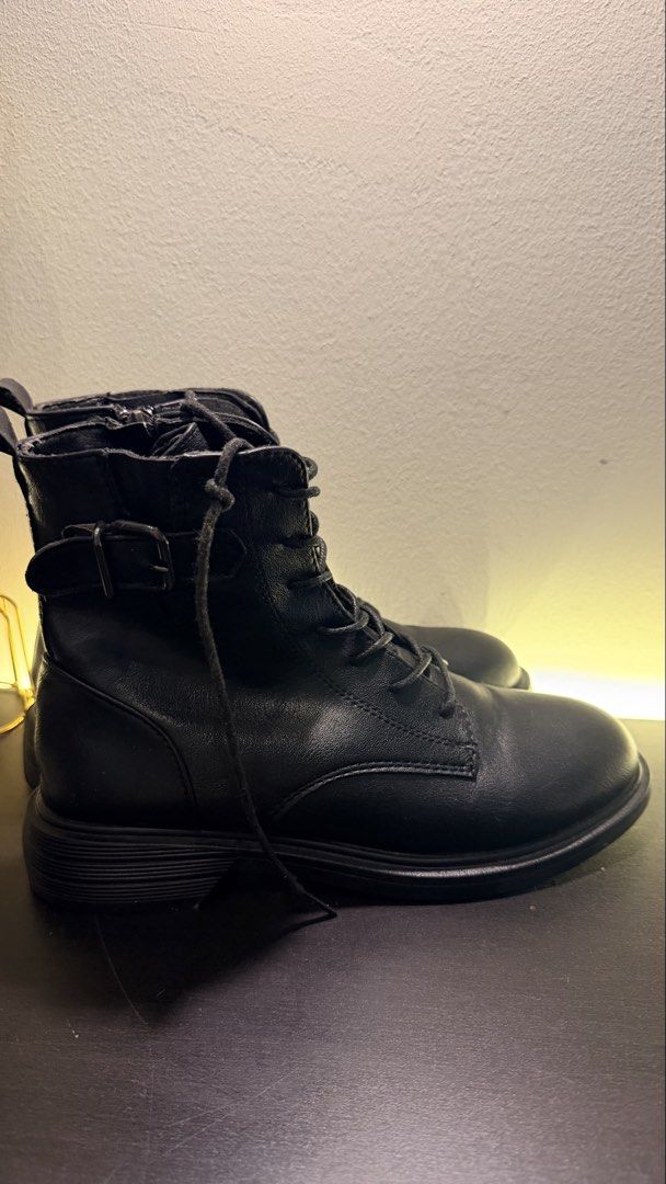 Black Lace-Up Combat Boots with Side Zip (Category: Boots) located in Kuala Lumpur. Submitted by kayhani (Listing ID 1447598722, Image 2). Description: - Black combat boots - Lace-up front with side zipper for easy on/off - Stylish buckle detail on the side - Chunky sole for a trendy look - Versatile for everyday wear.
