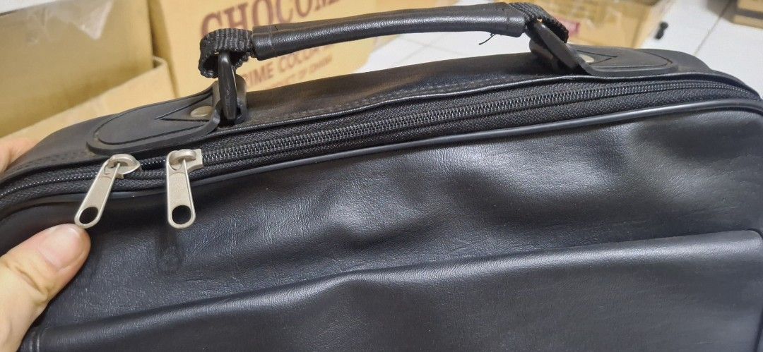 Black Leather Briefcase with Handle and Zippers (Category: Briefcases) located in Manila. Submitted by youngcloud_b1fffa (Listing ID 1447658875, Image 1). Description: - Genuine black leather briefcase - Comfortable top handle - Double zippers for main compartment security - Convenient front flap pocket with hidden closure - Accessible side pocket - Ideal for documents or a small laptop - Clean and well-maintained interior - Zippers operate smoot