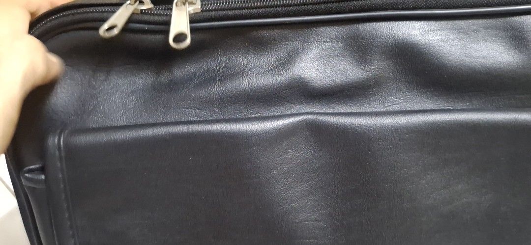 Black Leather Briefcase with Handle and Zippers (Category: Briefcases) located in Manila. Submitted by youngcloud_b1fffa (Listing ID 1447658875, Image 3). Description: - Genuine black leather briefcase - Comfortable top handle - Double zippers for main compartment security - Convenient front flap pocket with hidden closure - Accessible side pocket - Ideal for documents or a small laptop - Clean and well-maintained interior - Zippers operate smoot