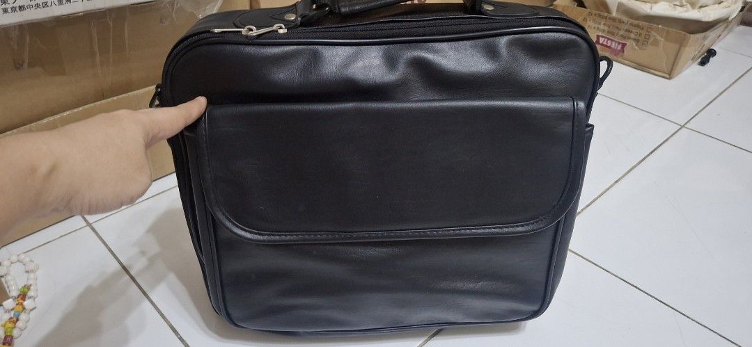Black Leather Briefcase with Handle and Zippers (Category: Briefcases) located in Manila. Submitted by youngcloud_b1fffa (Listing ID 1447658875, Image 2). Description: - Genuine black leather briefcase - Comfortable top handle - Double zippers for main compartment security - Convenient front flap pocket with hidden closure - Accessible side pocket - Ideal for documents or a small laptop - Clean and well-maintained interior - Zippers operate smoot