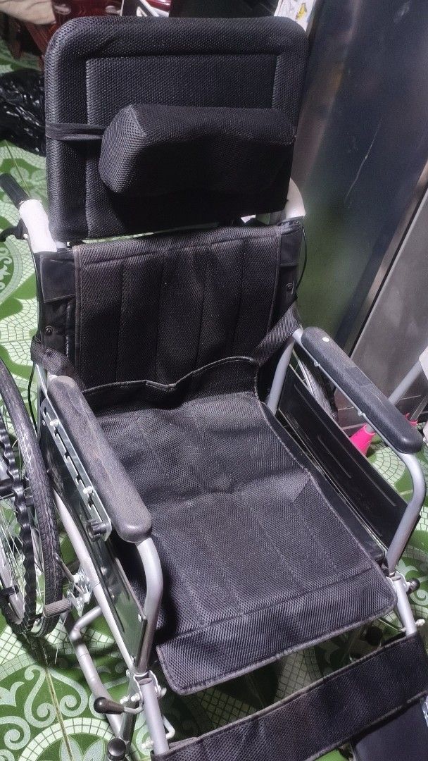 Black Wheelchair with Headrest and Cushion (Category: Wheelchairs) located in Caloocan City. Submitted by luluonlineshop (Listing ID 1447559094, Image 1). Description: For sale. - Black wheelchair with headrest for added support - Includes a comfortable blue gel cushion with a cutout - Adjustable armrests and footrests for personalized comfort - Sturdy wheels, ready for immediate use - Ideal for reliable mobility assistance.
