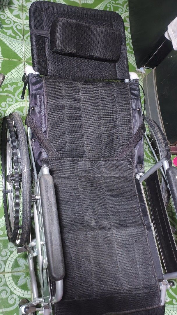 Black Wheelchair with Headrest and Cushion (Category: Wheelchairs) located in Caloocan City. Submitted by luluonlineshop (Listing ID 1447559094, Image 2). Description: For sale. - Black wheelchair with headrest for added support - Includes a comfortable blue gel cushion with a cutout - Adjustable armrests and footrests for personalized comfort - Sturdy wheels, ready for immediate use - Ideal for reliable mobility assistance.