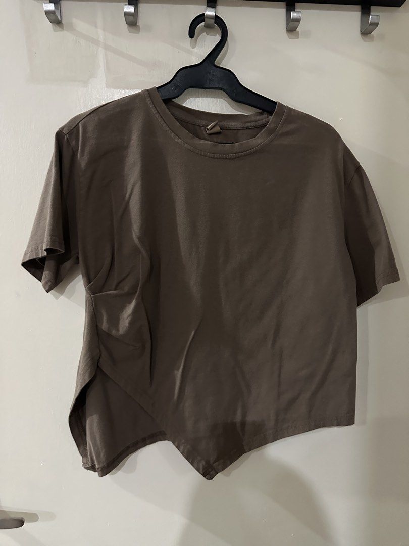 Brown Asymmetrical Hem Cropped T-shirt (Category: Shirts) located in Manila. Submitted by bellevd (Listing ID 1447548055, Image 1). Description: - Brown cropped t-shirt - Unique asymmetrical hem - Soft cotton blend fabric - Short sleeves - Crew neck - Modern, edgy design - Great for casual outfits - Easy to pair with jeans or skirts.