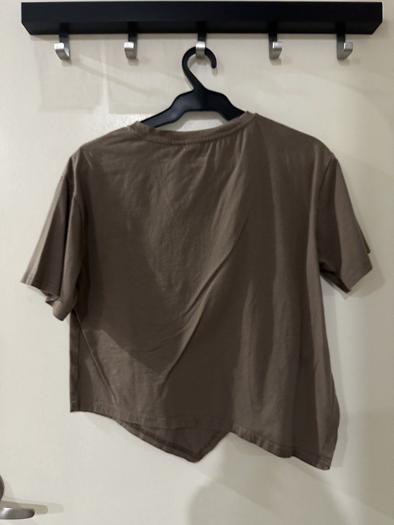 Brown Asymmetrical Hem Cropped T-shirt (Category: Shirts) located in Manila. Submitted by bellevd (Listing ID 1447548055, Image 2). Description: - Brown cropped t-shirt - Unique asymmetrical hem - Soft cotton blend fabric - Short sleeves - Crew neck - Modern, edgy design - Great for casual outfits - Easy to pair with jeans or skirts.