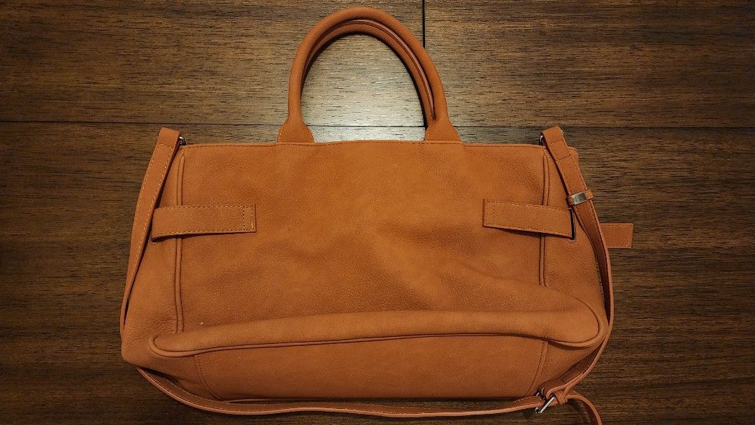 Brown Leather Tote Bag with Shoulder Strap (Category: Luxury Bags & Wallets) located in Manila. Submitted by amc88 (Listing ID 1447598485, Image 2). Description: - Spacious brown tote bag - Top handles and adjustable shoulder strap - Front pocket with buckle detail - Removalable front exterior- can be used as clutch - Interior zippered pocket - Ideal for everyday use - Plenty of room for essentials and can fit 13-inch laptop.