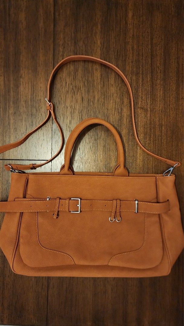 Brown Leather Tote Bag with Shoulder Strap (Category: Luxury Bags & Wallets) located in Manila. Submitted by amc88 (Listing ID 1447598485, Image 1). Description: - Spacious brown tote bag - Top handles and adjustable shoulder strap - Front pocket with buckle detail - Removalable front exterior- can be used as clutch - Interior zippered pocket - Ideal for everyday use - Plenty of room for essentials and can fit 13-inch laptop.