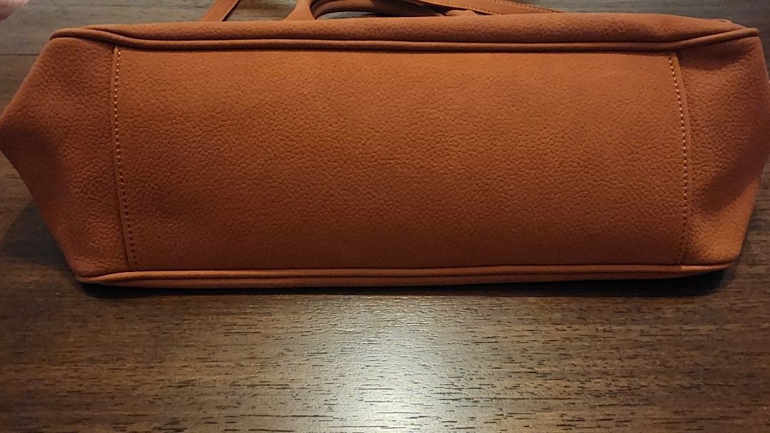 Brown Leather Tote Bag with Shoulder Strap (Category: Luxury Bags & Wallets) located in Manila. Submitted by amc88 (Listing ID 1447598485, Image 3). Description: - Spacious brown tote bag - Top handles and adjustable shoulder strap - Front pocket with buckle detail - Removalable front exterior- can be used as clutch - Interior zippered pocket - Ideal for everyday use - Plenty of room for essentials and can fit 13-inch laptop.