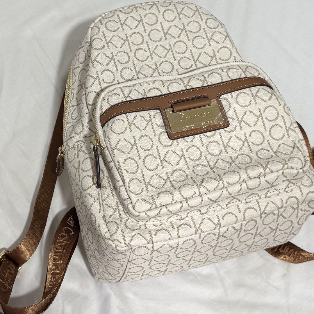 Brand New Calvin Klein Monogram Backpack (Category: Backpacks) located in Las Pinas. Submitted by randomnanything (Listing ID 1447505637, Image 2). Description: - Authentic Calvin Klein monogram backpack - Chic color combination: White and Beige - Elegant gold color hardware details - Adjustable straps with signature Calvin Klein branding - Practical interior zippered pocket - Unused/ Brand new with original tags attached - Original Price: around