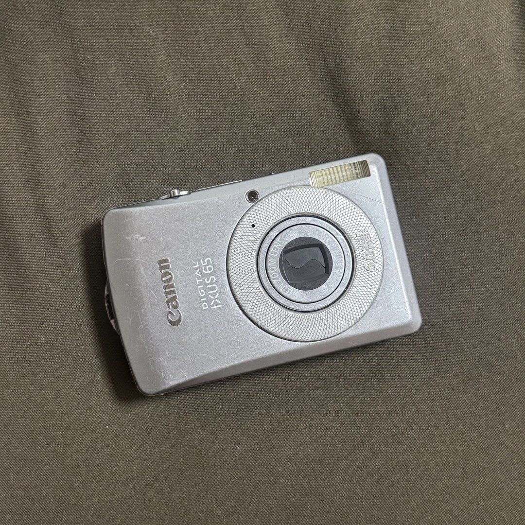 Canon Digital IXUS 65 Camera (Category: Cameras) located in Pasay City. Submitted by minrkluvs (Listing ID 1447589076, Image 2). Description: Canon Digital IXUS 65 Digi Camera Digi Cam - Fully functional - Working flash - All buttons are working - With battery, charger, A/V cable, CD’s, box and manuals. - 6.0 megapixels - CCD - 3x optical zoom - 3 inch LCD - Please do search the net for complete specs. - message me for pic samples! Issue: The cam