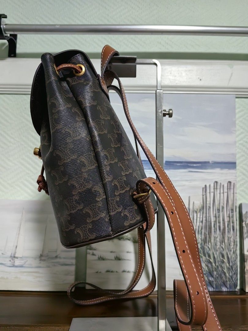 Celine Triomphe Canvas Mini Backpack (Category: Luxury Bags & Wallets) located in Quezon City. Submitted by flat.earther23 (Listing ID 1442986232, Image 2). Description: - Iconic Triomphe Canvas print - Brown leather trim and straps with white stitching - Gold hardware closure - Adjustable shoulder straps - Drawstring closure under flap - Ideal for everyday use.
