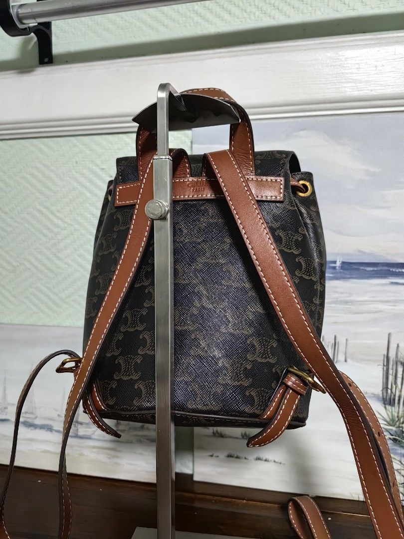 Celine Triomphe Canvas Mini Backpack (Category: Luxury Bags & Wallets) located in Quezon City. Submitted by flat.earther23 (Listing ID 1442986232, Image 3). Description: - Iconic Triomphe Canvas print - Brown leather trim and straps with white stitching - Gold hardware closure - Adjustable shoulder straps - Drawstring closure under flap - Ideal for everyday use.