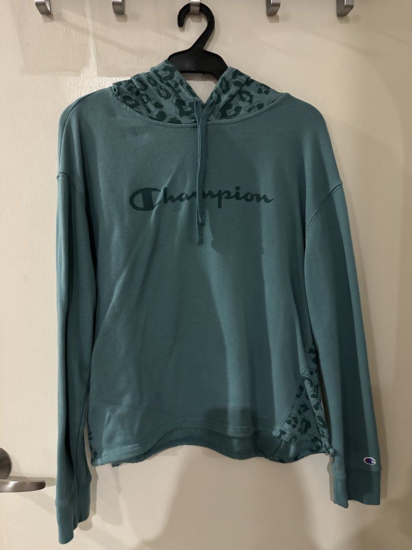 Champion Teal Leopard Print Hoodie (Category: Hoodies) located in Manila. Submitted by bellevd (Listing ID 1447548335, Image 1). Description: - Teal Champion hoodie - Features leopard print accents on hood and sides - Long sleeves - Drawstring hood - Casual and comfortable design - Perfect for everyday wear.