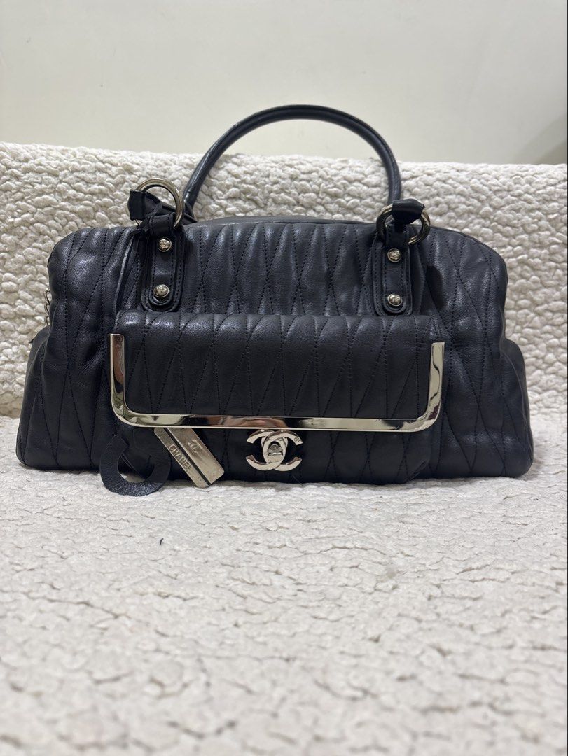 Chanel Black Quilted Leather Handbag (Category: Luxury Bags & Wallets) located in Pasig City. Submitted by ddrose16 (Listing ID 1434388411, Image 1). Description: - Black quilted leather handbag - Top handle / Shoulder bag design - Front pocket with silver-tone frame and Chanel logo - Detachable Chanel logo charm and 'C' charm - Black interior lining with Chanel label - Zipper closure - Metal feet on the bottom RFS: Decluttering — Disclaimer: no 
