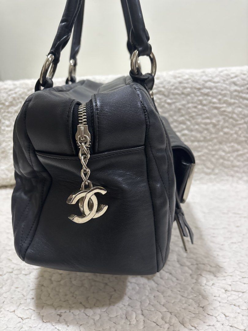 Chanel Black Quilted Leather Handbag (Category: Luxury Bags & Wallets) located in Pasig City. Submitted by ddrose16 (Listing ID 1434388411, Image 3). Description: - Black quilted leather handbag - Top handle / Shoulder bag design - Front pocket with silver-tone frame and Chanel logo - Detachable Chanel logo charm and 'C' charm - Black interior lining with Chanel label - Zipper closure - Metal feet on the bottom RFS: Decluttering — Disclaimer: no 