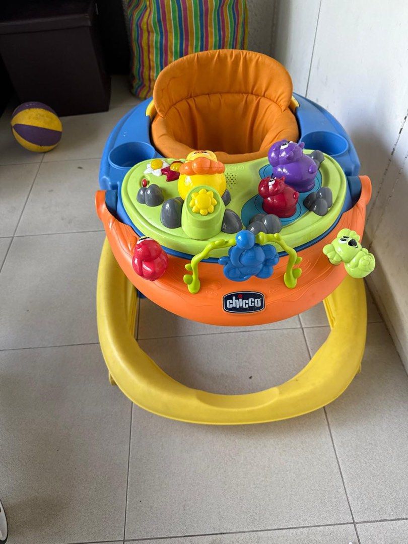 Chicco Baby Walker with Toys (Category: Infant Playtime) located in Manila. Submitted by omiuttam (Listing ID 1447579728, Image 3). Description: - Brightly colored Chicco baby walker - Fun activity tray with interactive toys - Comfortable orange padded seat - Sturdy base with wheels for easy movement - Helps baby explore and learn.