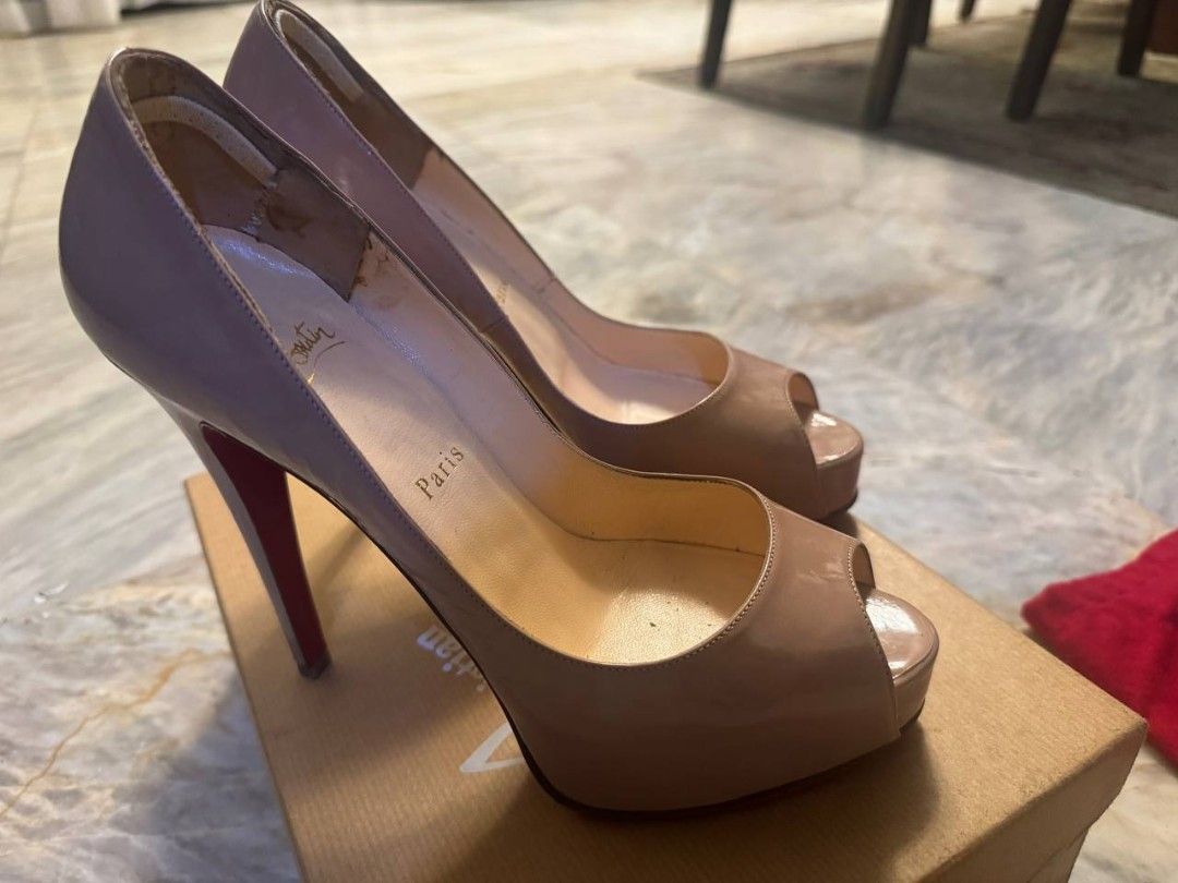 Christian Louboutin Peep-Toe Heels (Category: Heels) located in Makati City. Submitted by kateeyap (Listing ID 1447632525, Image 2). Description: - Classic Christian Louboutin peep-toe heels - Nude/beige patent leather - Iconic red soles - Includes original box and dust bag - Barely worn but has been in the box for years. More pictures available upon request. - Needs some TLC hence selling low. price is still slighly negotiable..