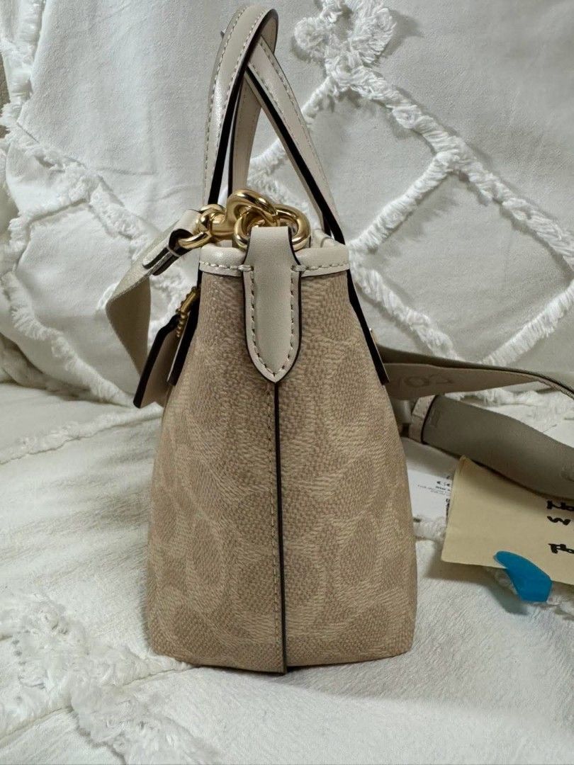 Coach Signature Canvas Mini Tote Bag (Category: Luxury Bags & Wallets) located in Bulacan. Submitted by vintage_purge (Listing ID 1447524133, Image 3). Description: - Coach mini tote bag - Signature canvas in beige and cream - Top handles - Detachable crossbody strap - Gold hardware details - Includes Coach tag - Ideal for everyday use.