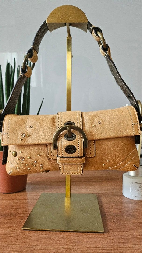 Coach Soho Demi Flap (Category: Luxury Bags & Wallets) located in Quezon City. Submitted by smariemerc46809 (Listing ID 1447503011, Image 1). Description: - Authentic Coach Soho Demi Flap - Stylish buckle closure - All-over decorative stud and rhinestones embellishments - Preloved Excellent condition.